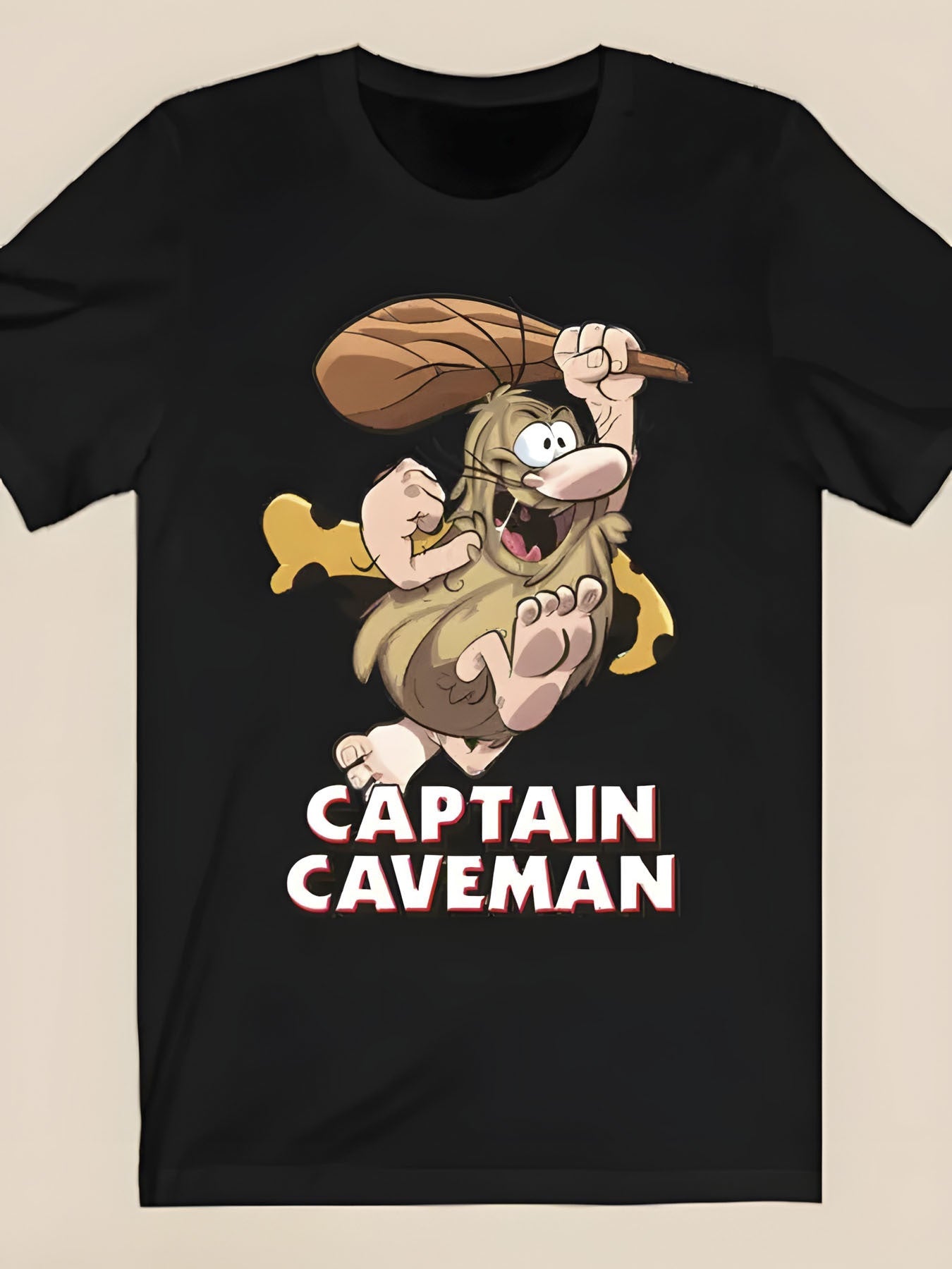 Plus Size - Plus Size - Black T-Shirt Featuring a Cartoon Caveman Design with Wild Hair, a Thick Beard, And an Expressive Face, Holding a Wooden Stick. It Has The Striking Text 'Caveman Captain', a Relaxed Fit, And Is Made from Soft Material